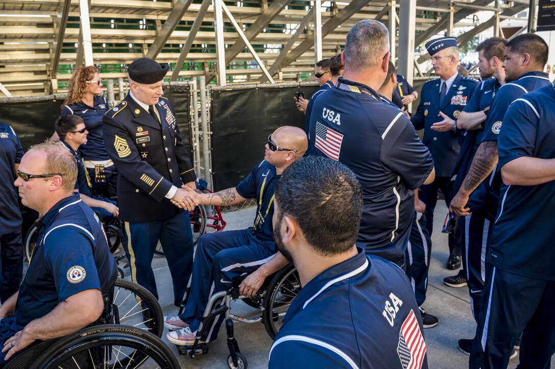 Air Force Gen. Paul J. Selva, background right, vice chairman of the Joint Chiefs of Staff, and Army Command Sgt. Maj. John W. Troxell, standing left, senior enlisted advisor to the chairman of the Joint Chiefs of Staff, talk with members of the U.S. team before the 2016 Invictus Games opening ceremonies in Orlando, Fla., May 8, 2016. DoD photo by Army Staff Sgt. Sean K. Harp