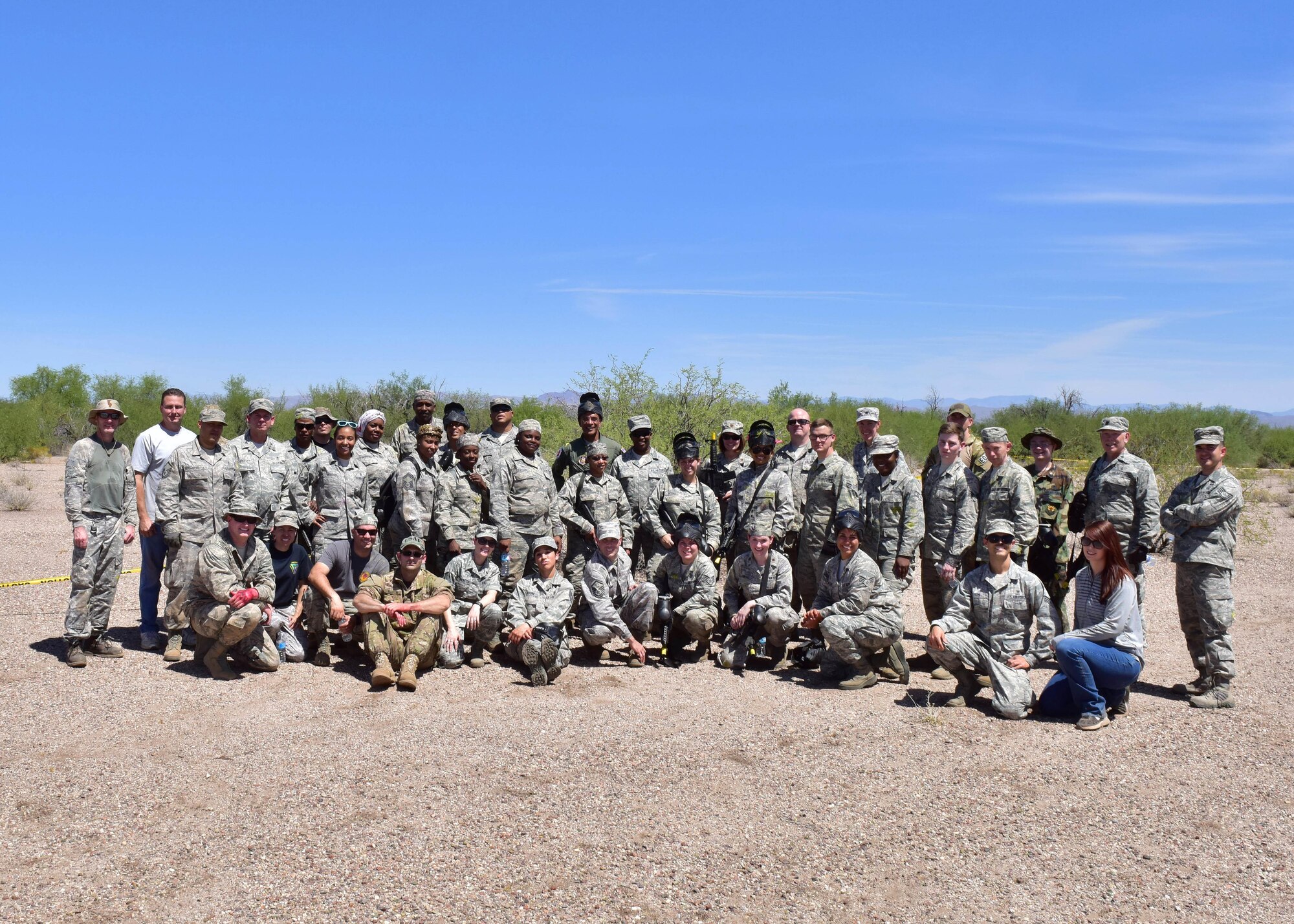 Airmen from the 403rd and 944th Aeromedical Staging Squadron pose for a group photo after conducting a Tactical Combat Casualty Care training exercise Apr 22 at Luke Air Force Base Auxiliary Field 1, Ariz. (U.S. Air Force photo by Tech. Sgt. Louis Vega Jr.)