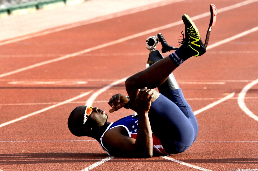 Army veteran William Reynolds collapses on the track after winning a 100-meter sprint event at the track and field finals during the 2016 Invictus Games in Orlando, Fla., May 10, 2016. Air Force photo by Staff Sgt. Carlin Leslie