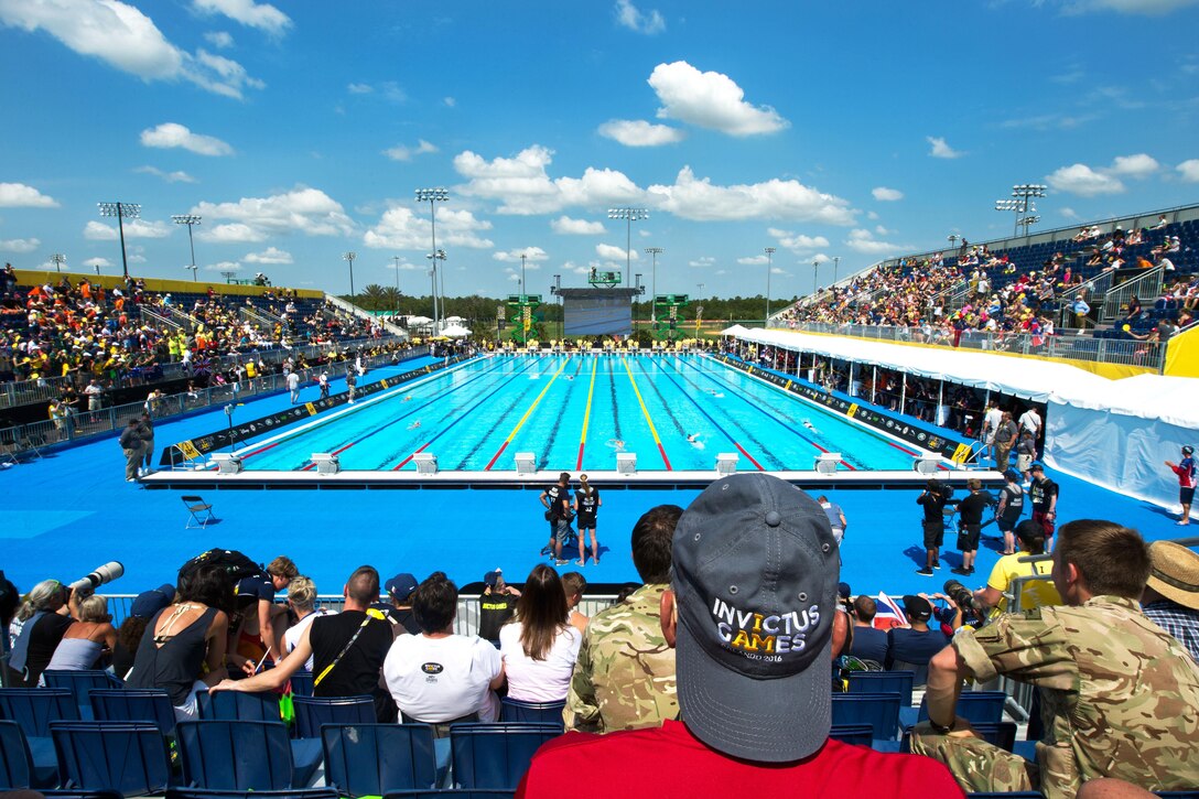 Spectators watch a women’s preliminary swim competition during the 2016 Invictus Games in Orlando, Fla., May 11, 2016. DoD photo  by Edward Joseph Hersom II