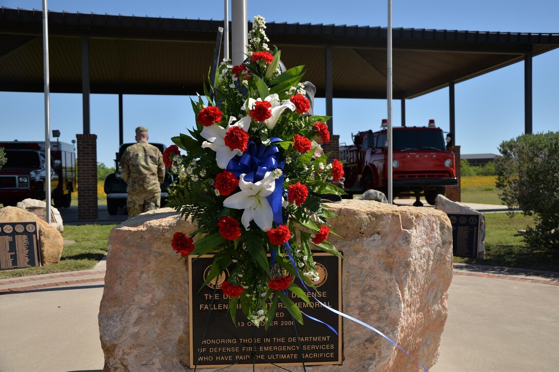 A wreath placed during a memorial ceremony stands in honor of the firefighters who fell in the line of duty at the Fallen Firefighter Memorial on Goodfellow Air Force Base, Texas, May 6, 2016. The ceremony included a moment of silence, a wreath laying and words spoken in remembrance of the fallen firefighters. (U.S. Air Force photo by Airman 1st Class Randall Moose/Released)