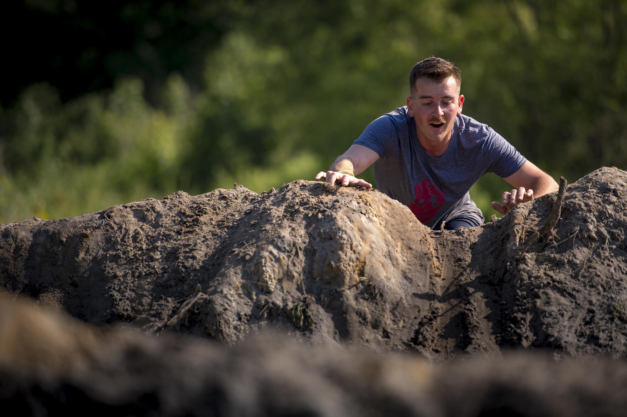 A runner looks over the top of an obstacle during the 2016 Moody Mudder, May 7, 2016, in Ray City, Ga. The Mudder challenged nearly 500 competitors to complete 20 obstacles on a 3.12-mile course for the third year in a row. (U.S. Air Force photo by Senior Airman Ryan Callaghan/Released)