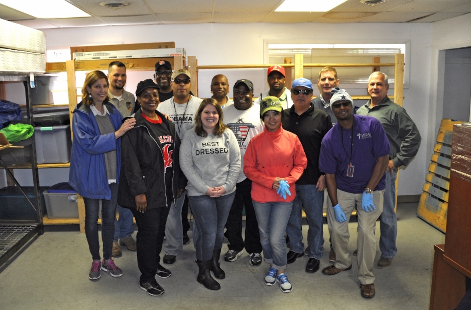 DLA employees from the Disposal Policy and Compliance Division join Lorton Community Action Center thrift store manager Melissa Deutsch (far left) for a group photo after completing the team building exercise/community project in Lorton, Virginia, May 10.