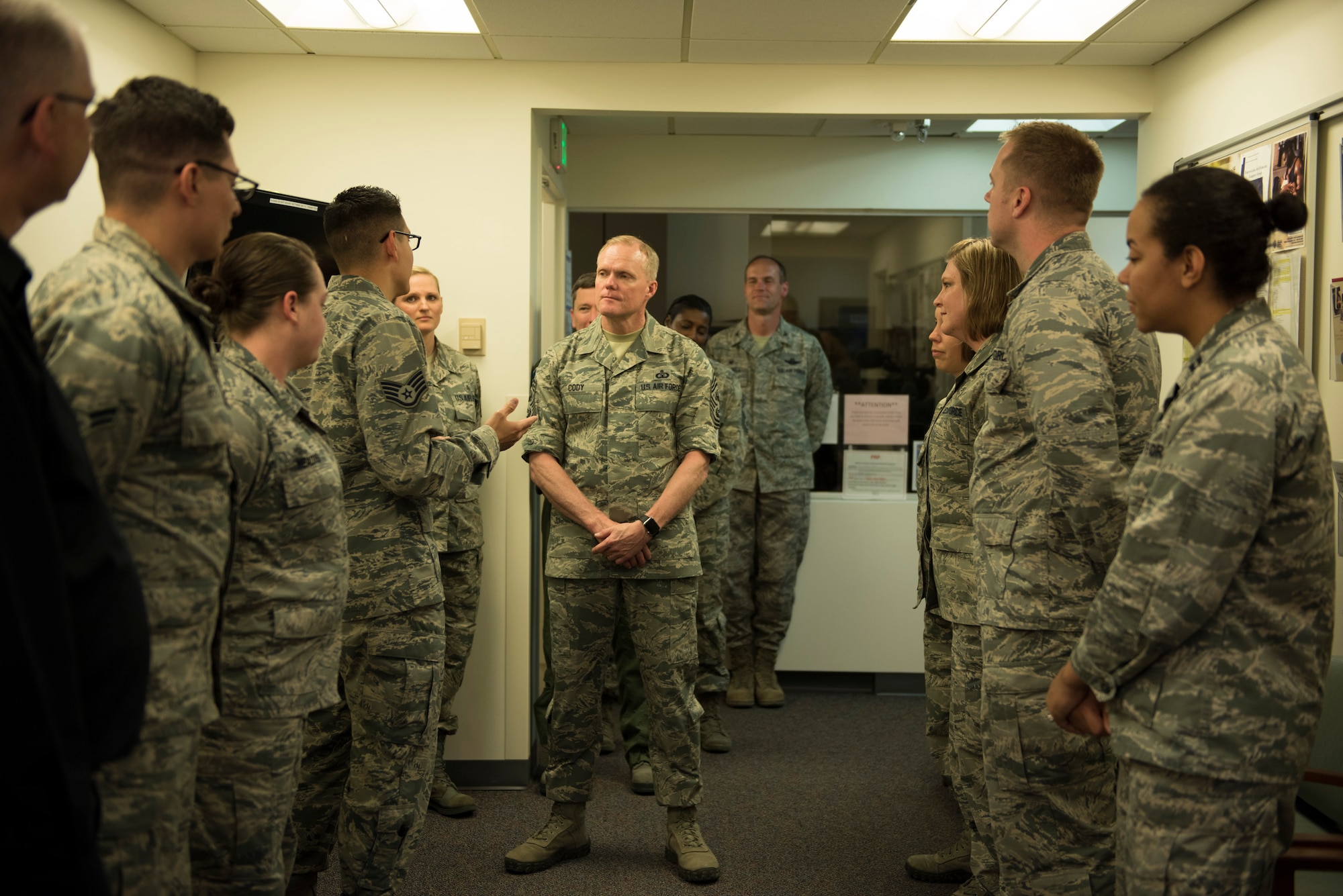 Staff Sgt. Landon Miracle, 366th Medical Operations Squadron mental health flight NCO in charge, briefs Chief Master Sgt. of the Air Force James Cody, May 5, 2016, at Mountain Home Air Force Base, Idaho. Cody discussed taking a more proactive approach to mental health to aid with the overall wellbeing of airmen. (U.S. Air Force photo by Airman Alaysia Berry/Released)