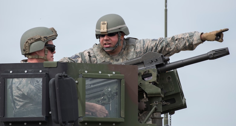 Staff Sgt. Andrew Schick, 366th Security Forces Squadron combat arms instructor, gives Chief Master Sgt. of the Air Force James Cody guidance on where to aim during target practice with a MK 19 Mod 3 May 5, 2016, at Mountain Home Air Force Base, Idaho. Cody was hitting targets approximately 1,500 meters away. The MK 19 has a maximum range of more than 2,000 meters. (U.S. Air Force photo by Airman 1st Class Chester Mientkiewicz/Released)