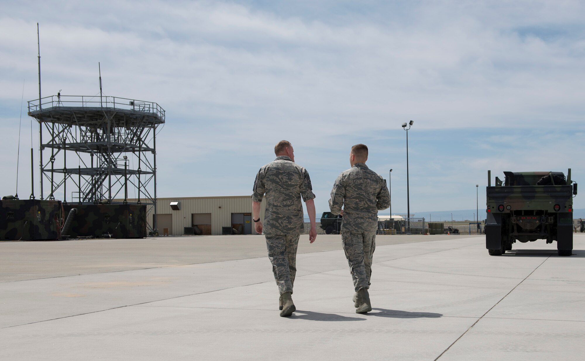 Chief Master Sgt. of the Air Force James Cody walks with an airman from the 726th Air Control Squadron during a visit May 5, 2016, at Mountain Home Air Force Base, Idaho. Cody interacted with airmen in various squadrons around base. (U.S. Air Force photo by Airman 1st Class Chester Mientkiewicz/Released)