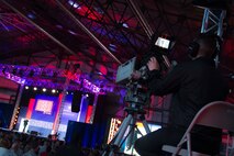 A cameraman captures footage during a USO celebration of its 75th birthday, Military Appreciation Month and the 5th Anniversary of Joining Forces in a hangar on Joint Base Andrews May 5. The special event, called a “Celebration of Service,” featured special guest speakers President and First Lady Obama, Vice President and Second Lady Biden and comedic performances by Jon Steward, David Letterman, Judd Apatow, Mike Birbiglia, Kristen Schaal, Hasan Minhaj, John Mulaney and Jeff Ross. (U.S. Air Force photo/Staff Sgt. Kat Justen)