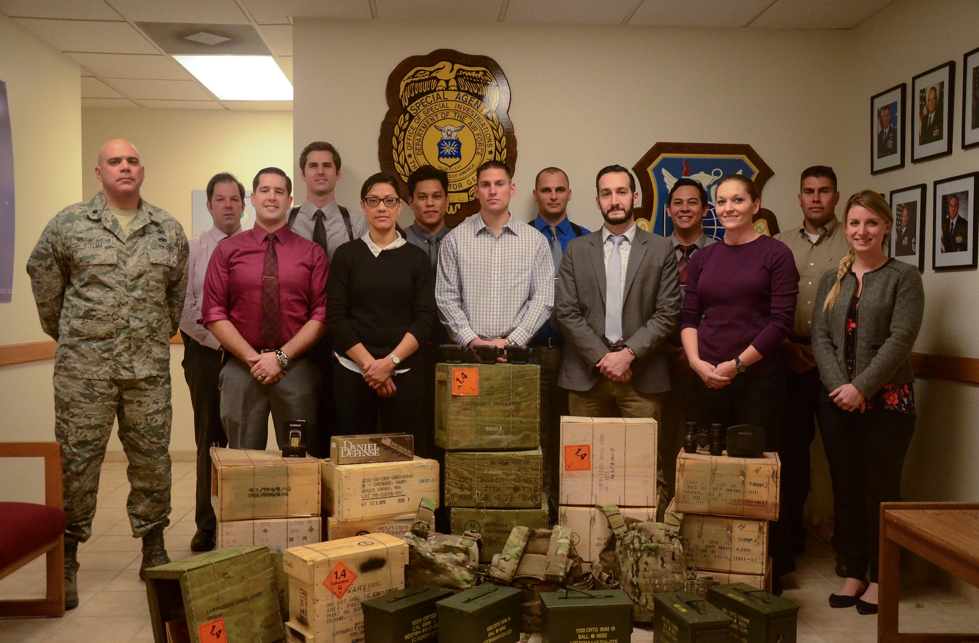 Air Force Office of Special Investigations detachment 206, stands behind ceased material after successfully completing a case during 2015 at Nellis Air Force Base, Nev. During 2015, det. 206 ran 125 cases in which they would cease stolen material, conduct busts and would receive confessions for crimes. For their actions, det. 206 was recognized as the best large Air Force OSI detachment. (Courtesy photo)
