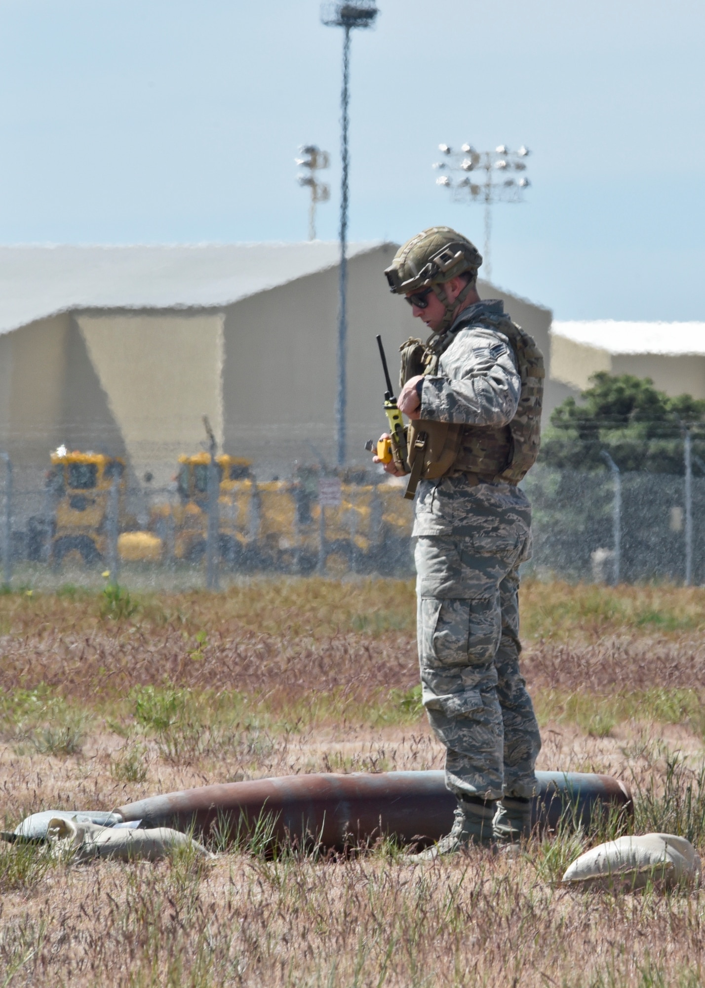 Senior Airman Luke Peterson, 92nd Civil Engineer Squadron explosive ordinance disposal technician, conducts render safe procedures to disarm a mock MK82, during a training exercise May 11, 2016, at Fairchild Air Force Base, Wash. The crews responded to a simulated aircraft crash where an F-18 experienced various mechanical issues and clipped a nearby structure. During the descent, the pilot was forced to drop armament and then eject. (U.S. Air Force photo/Airman 1st Class Taylor Bourgeous) 