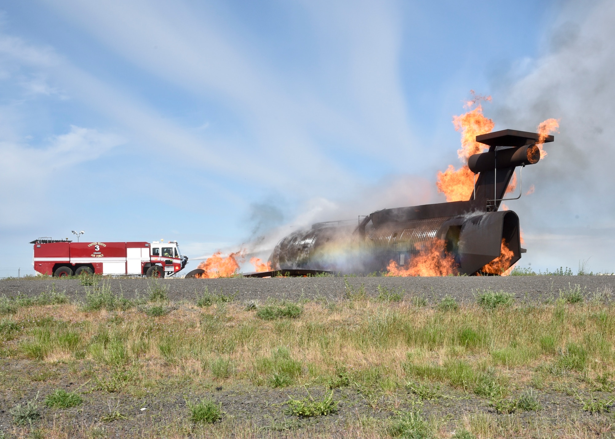92nd Civil Engineer Squadron firefighters work to put out flames during a simulated aircraft incident May 11, 2016, at Fairchild Air Force Base, Wash. The training involved various 92nd CES agencies including members from the Fire Department, Emergency Management, Environmental and Explosive Ordinance Disposal; working together to resolve the incident. (U.S. Air Force photo/Airman 1st Class Taylor Bourgeous)