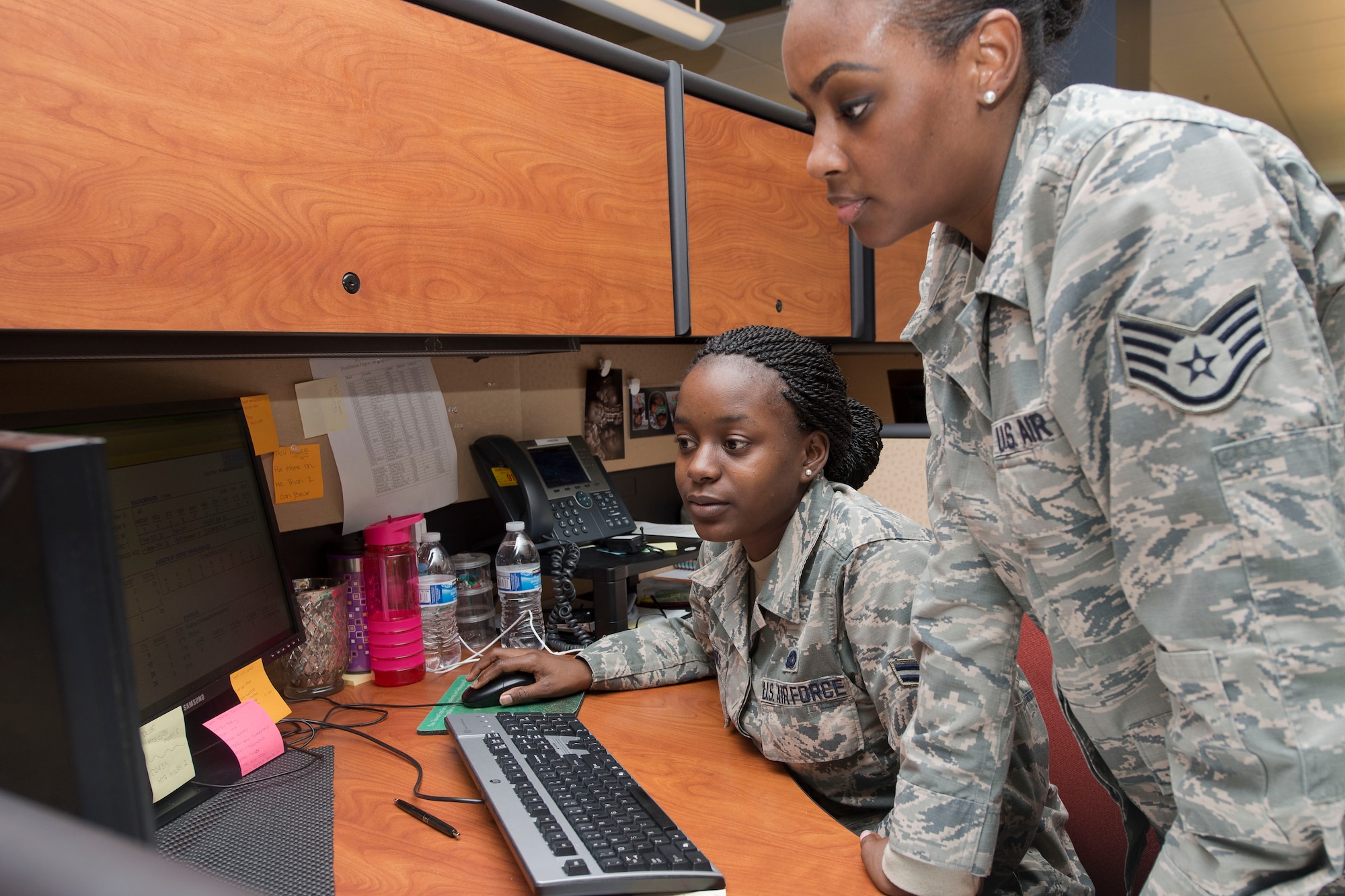 U.S. Air Force Staff Sgt. Erica Jacobs, a mission impaired awaiting parts (MICAP) supervisor assigned to the 439th Supply Chain Operations Squadron, provides guidance to Airman 1st Class Domonique Barnes, a MICAP technician assigned to the 439th SCOS at Langley Air Force Base, Va., March 16, 2016. Jacobs and Barnes ensure Air Force installations receive the correct parts to aircrafts that need repairs to accomplish their mission. (U.S. Air Force photo by Airman 1st Class Derek Seifert) 