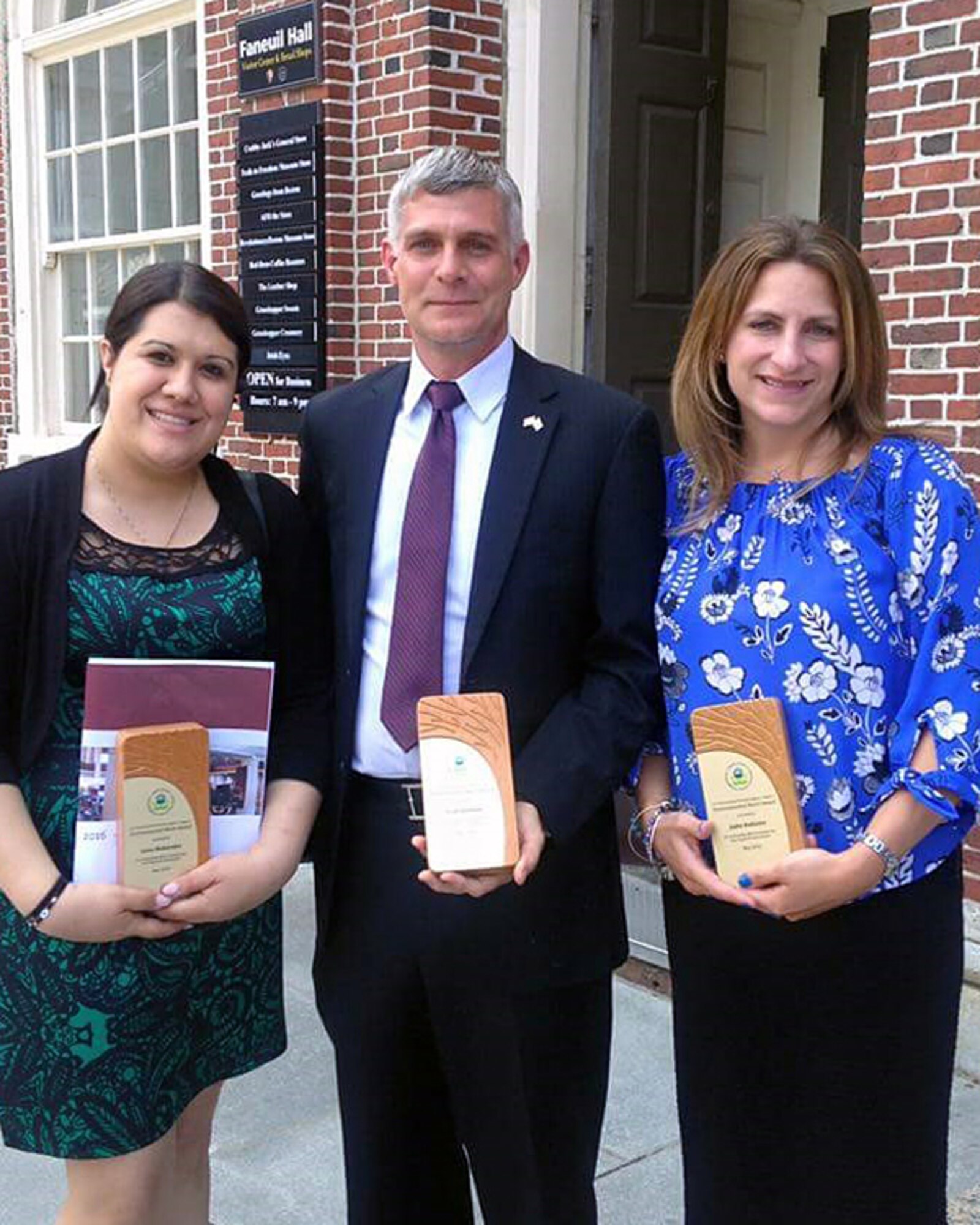 Anna Maherakis, left-to-right, MIT Lincoln Laboratory’s transportation coordinator, Scott Sheehan, an environmental engineer with the 66th Civil Engineering Division, and Jodie Hollister, New England account manager for vRIDE, received an Environmental Merit Award this week during an awards ceremony at Faneuil Hall in Boston. The annual award recognizes outstanding environmental advocates who have made significant contributions toward preserving and protecting natural resources throughout New England. (Courtesy photo)