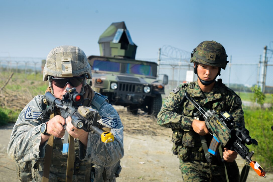 Staff Sgt. John Gavin, 51st Security Forces Squadron fire team leader, and a special operations forces member from the Republic of Korea army work together during a training scenario for Beverly Herd 16-01 May 10, 2016, at Osan Air Base, Republic of Korea. BH 16-01 is a week-long readiness exercise for the 51st Fighter Wing that includes a plethora of scenarios like chemical, biological, radioactive, and nuclear response, active shooter and opposing forces. (U.S. Air Force photo by Senior Airman Dillian Bamman/Released)
