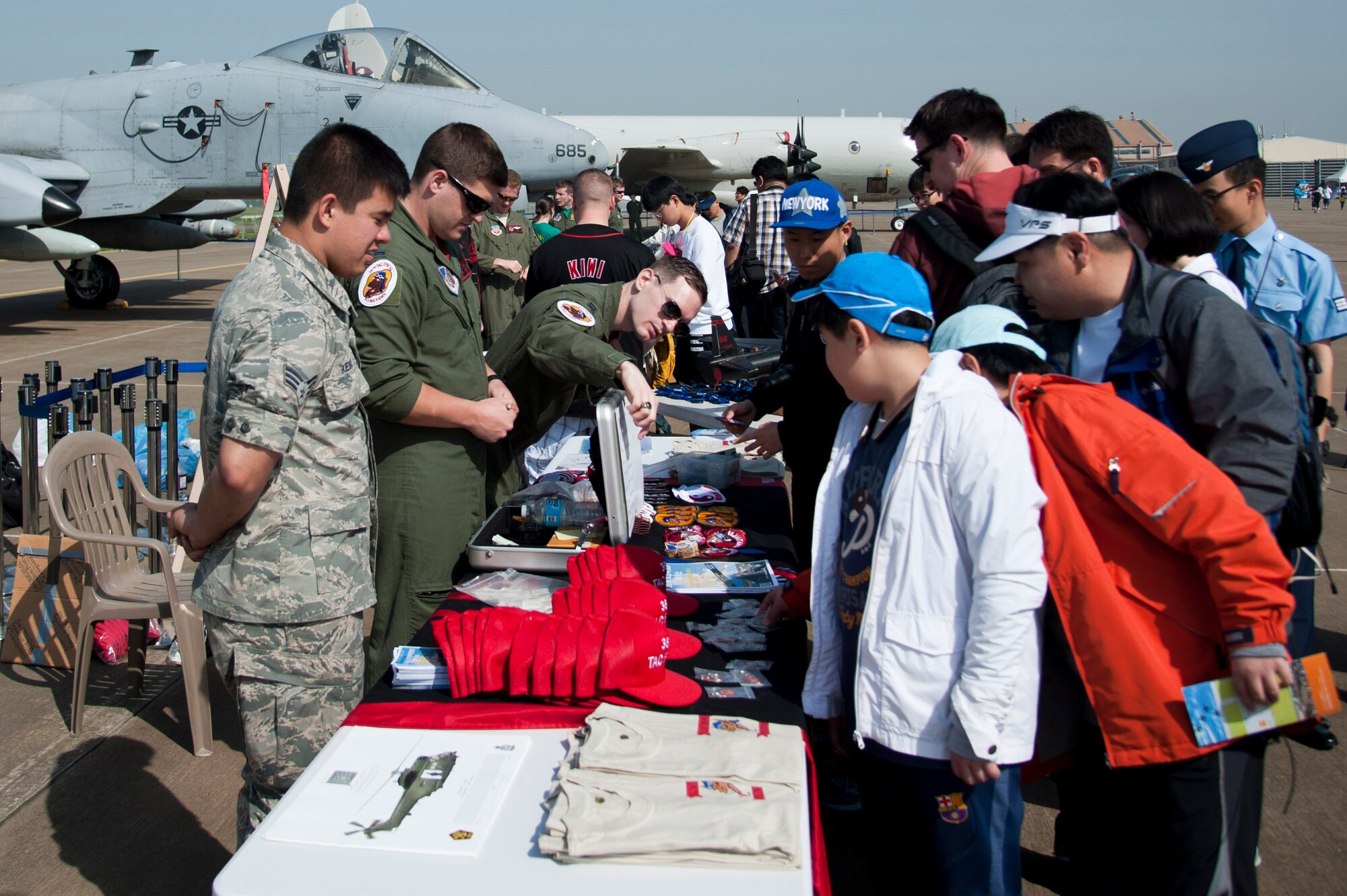 Maintainers and pilots from the 51st Maintenance Squadron 36th Fighter Squadron, 25th Fighter Squadron and 5th Reconnaissance speak with attendees during the Gyeonggi Suwon Airshow 2016 at Suwon Air Base, Republic of Korea, May 7, 2016. Maintainers and pilots from the 51st Aircraft Maintenance Squadrons, 36th Fighter Squadron, 25th Fighter Squadron and 5th Reconnaissance Squadron took photos and answered questions during the airshow. (U.S. Air Force photo by Staff Sgt. Jonathan Steffen/Released)