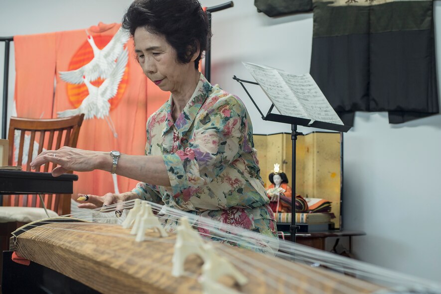 Setsuko Osada plays the koto during the Military Spouse Appreciation Day event at Yokota Air Base, Japan, May 6, 2016. The koto is an instrument made from paulownia wood with 13 strings and was introduced to Japan from China during the 7th and 8th centuries. (U.S. Air Force photo by Senior Airman David C. Danford/Released)