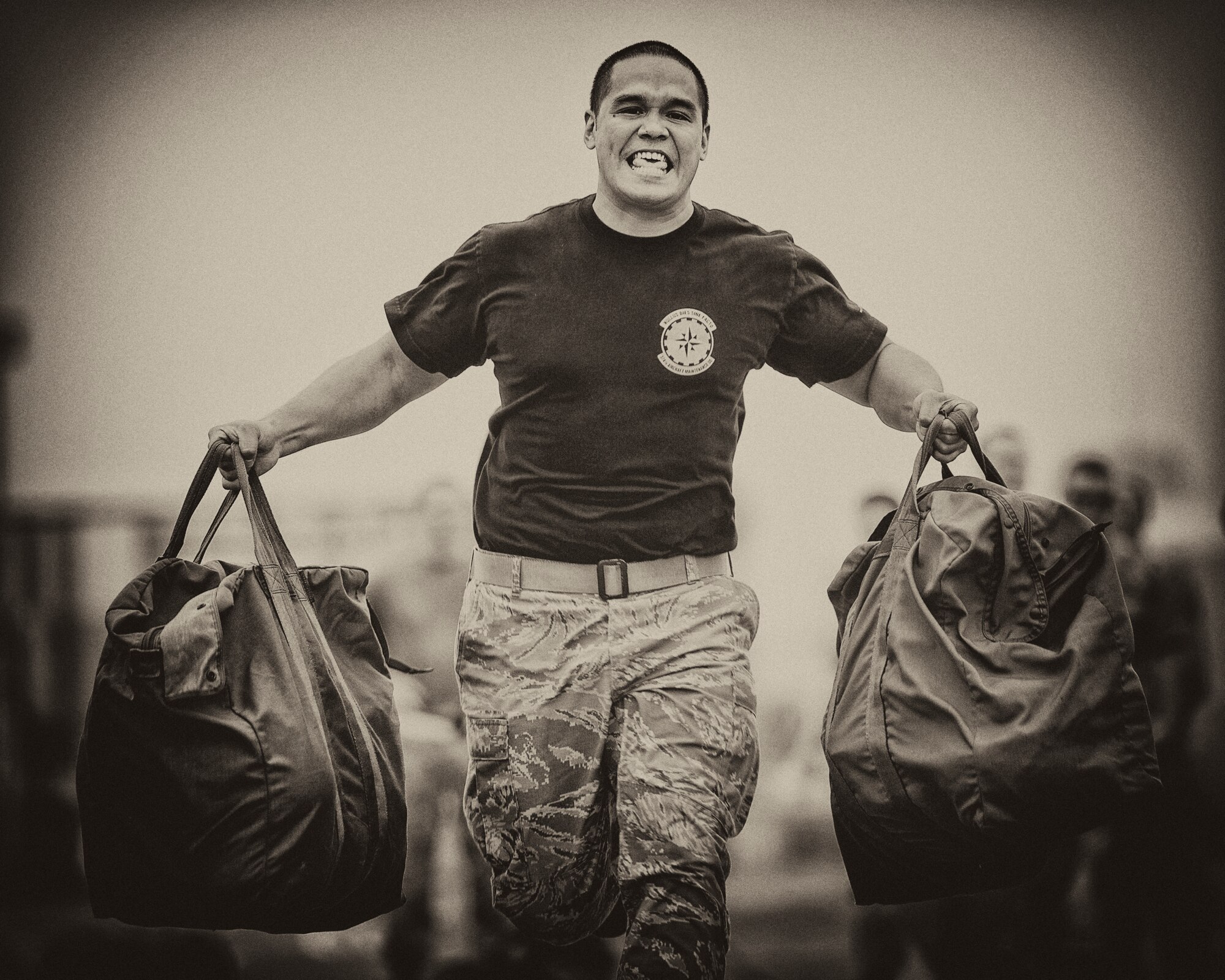 Staff Sgt. David Archer, 374th Aircraft Maintenance Squadron crew chief, carries gear bags during the Mission Oriented Protective Postures (MOPP) and Self Aid Buddy Care timed event for the 730th Air Mobility Squadron Maintenance Rodeo at Yokota Air Base, Japan, May 6, 2016. Six teams participated in the rodeo which had a variety of challenges: tool box inventory, safety wire skill, vehicle tow bar push, power cart relay race and MOPP and SABC timed event. (U.S. Air Force photo by Yasuo Osakabe/Released)