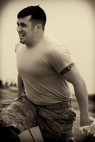 Staff Sgt. Joseph Lafaille, 374th Maintenance Squadron, runs with two chocks in the relay race, during the 730th Air Mobility Squadron Maintenance Rodeo at Yokota Air Base, Japan, May 6, 2016. Six teams participated in the rodeo which had a variety of challenges: tool box inventory, safety wire skill, vehicle tow bar push, power cart relay race and Mission Oriented Protective Postures (MOPP) gear and Self Aid Buddy Care (SABC) timed event. (U.S. Air Force photo by Yasuo Osakabe/Released) 
