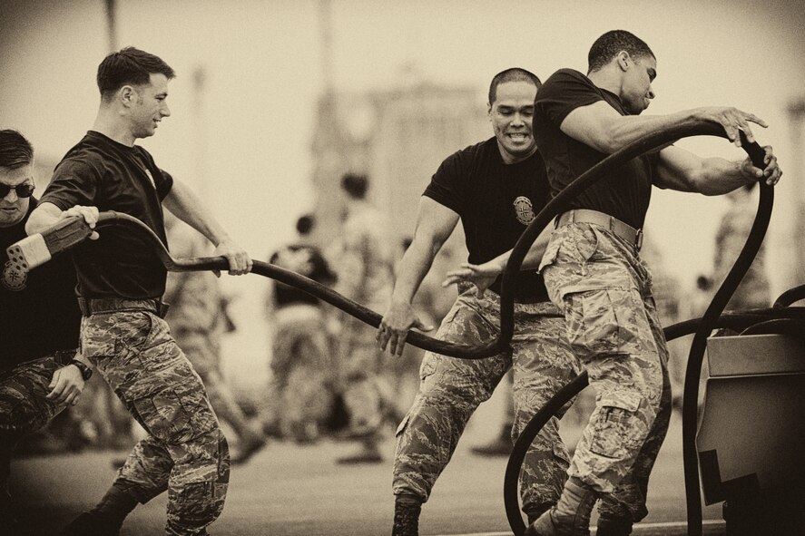 A team with the 374th Aircraft Maintenance Squadron rolls up a power cable during a relay race for the 730 AMS Maintenance Rodeo at Yokota Air Base, Japan, May 6, 2016. Six teams participated in the rodeo which had a variety of challenges: tool box inventory, safety wire skill, vehicle tow bar push, power cart relay race and Mission Oriented Protective Postures (MOPP) gear and Self Aid Buddy Care (SABC) timed event. (U.S. Air Force photo by Yasuo Osakabe/Released) 