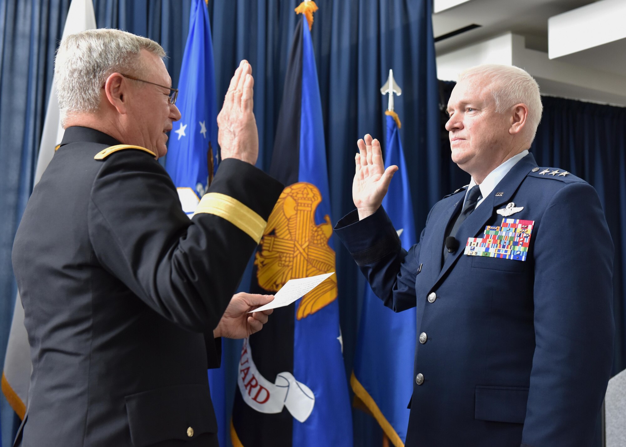 Air Force Lt. Gen. L. Scott Rice reaffirms his oath of office during a promotion and assumption of responsibility ceremony hosted by Army Gen. Frank J. Grass at the Air National Guard Readiness Center on Joint Base Andrews May 10, 2016. Rice, who previously served as the adjutant general of the Massachusetts National Guard, became the 14th director of the ANG. (U.S. Army National Guard photo by Staff Sgt. Michelle Gonzalez/Released)