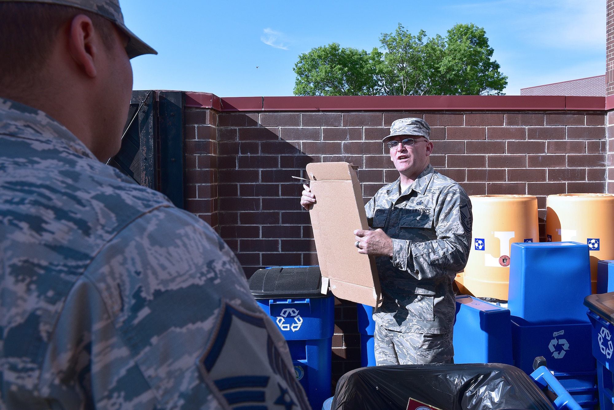 MCGHEE TYSON AIR NATIONAL GUARD BASE, Tenn. - Logistics Manager, Master Sgt. Don Pierson, right, and Master Sgt. Jose A. Santiago, Services manager, break down boxes disguarded at the recycle area here May 10, 2016, at the I.G. Brown Training and Education Center. Pierson is preparing Santiago for many unrealized and unseen support duties on campus before he departs for a reassignment in Texas. (U.S. Air National Guard photo by Master Sgt. Mike R. Smith/Released)
