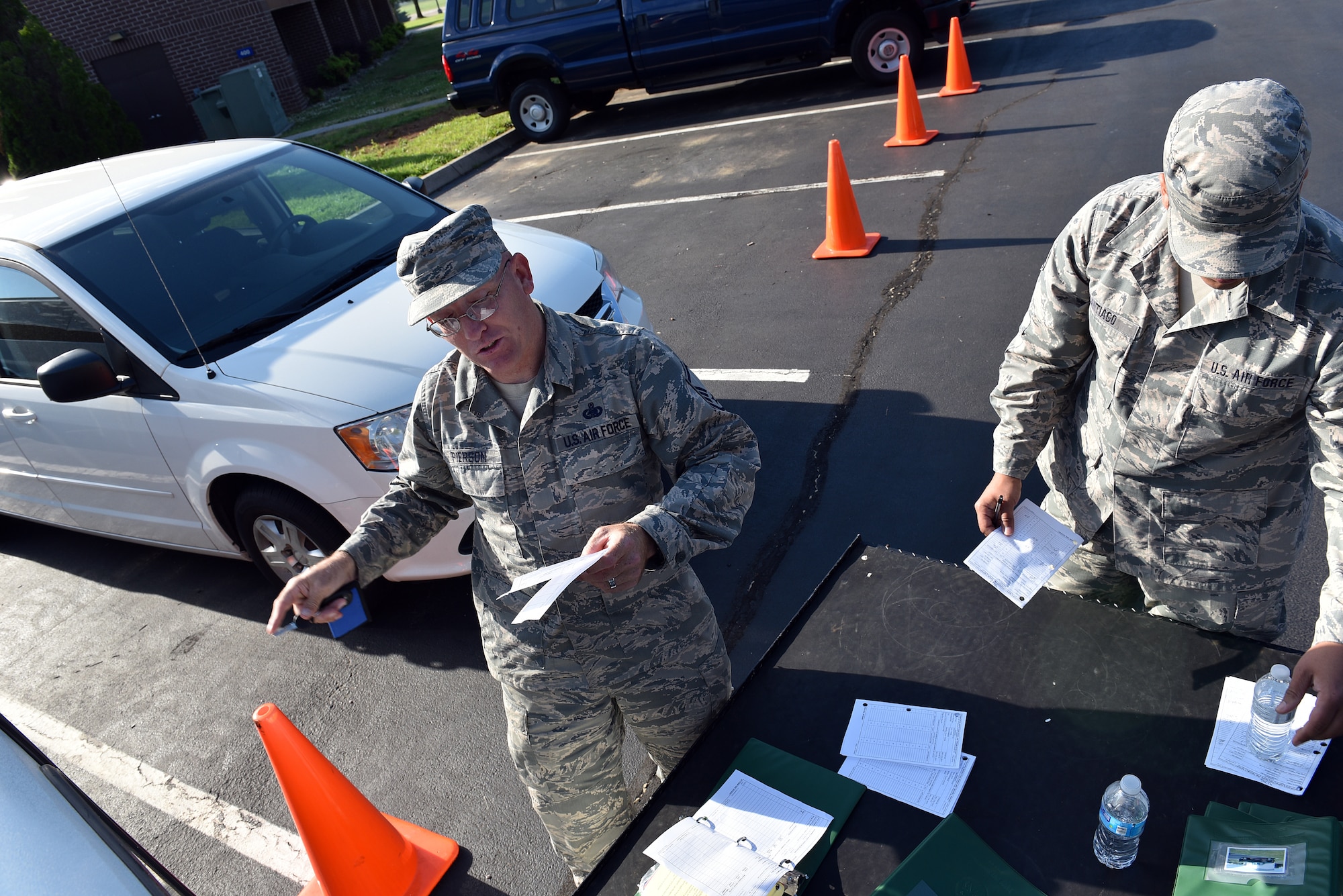MCGHEE TYSON AIR NATIONAL GUARD BASE, Tenn. - Logistics Manager, Master Sgt. Don Pierson, left, and Master Sgt. Jose A. Santiago, Services manager, perform periodic maintenance on government vehicles here May 10, 2016, while managing morning duties at the I.G. Brown Training and Education Center. Pierson is preparing for reassignment after more than 10 years' service on campus. (U.S. Air National Guard photo by Master Sgt. Mike R. Smith/Released)