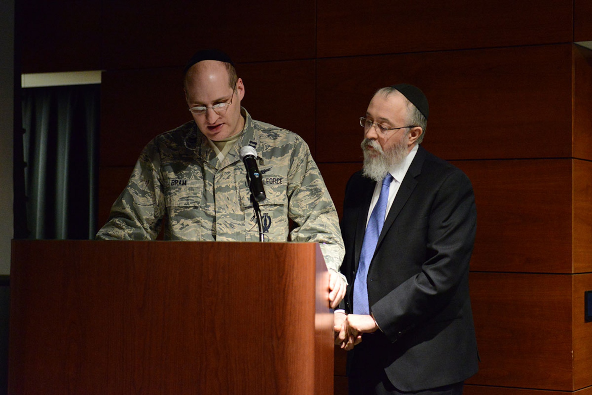 U.S. Air Force Chaplain (Capt.) Michael Bram, 673d Air Base Wing, and Rabbi Yosef Greenberg give the invocation at the Holocaust Remembrance Day event at the Arctic Warrior Event Center on Joint Base Elmendorf-Richardson, Alaska, May 6, 2016. The event theme for 2016 was “everyone has a story.” Stories were told throughout the event highlighting extraordinary people who survived one of the most horrific events in world history. (U.S. Air Force photo by Airman 1st Class Jared Bunn)