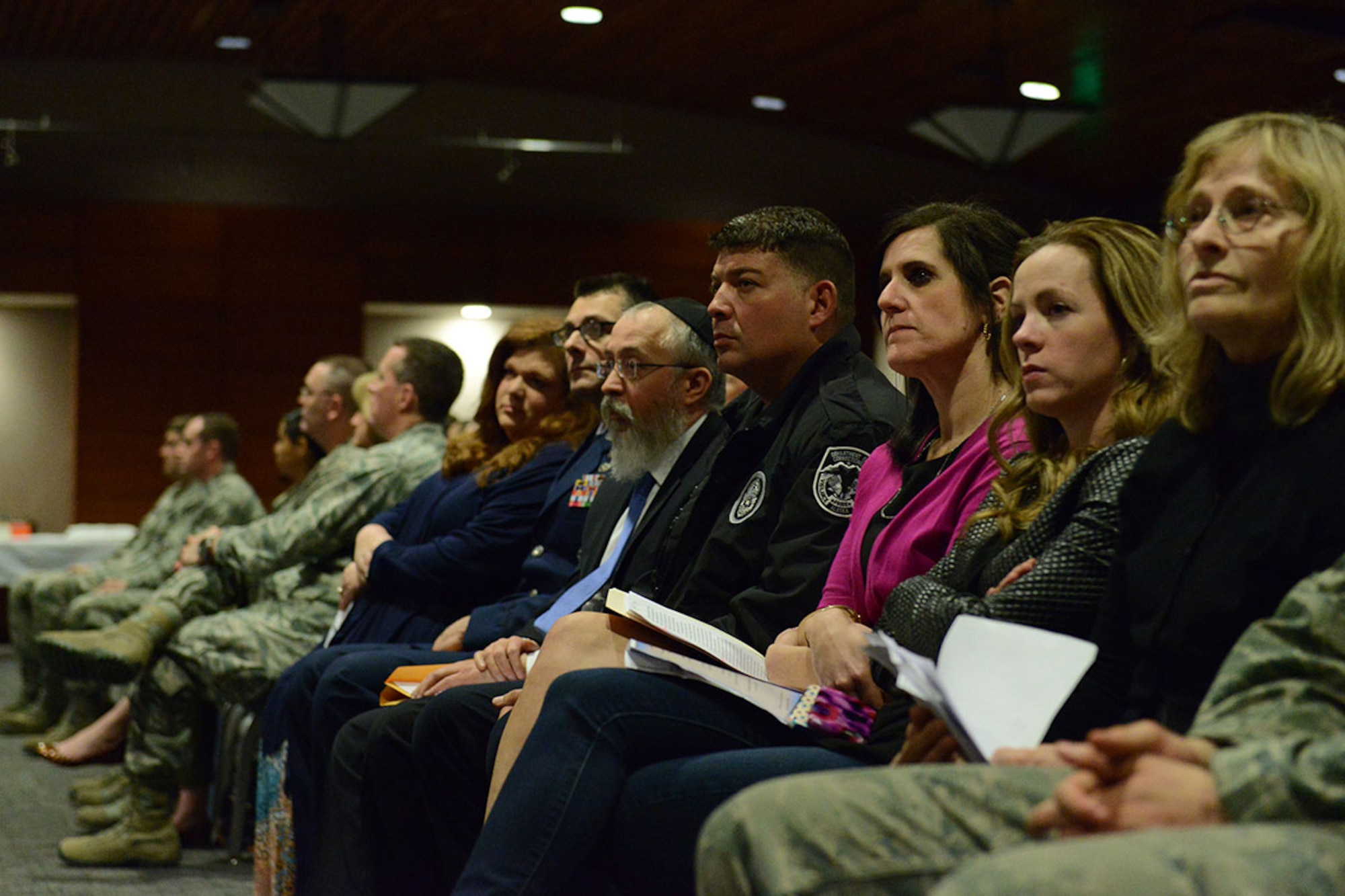 Attendees attentively listen as the Holocaust Remembrance Day event commences at the Arctic Warrior Event Center on Joint Base Elmendorf-Richardson, Alaska, May 6, 2016. According to the United States Holocaust Memorial Museum, the observance of the day was established in 1951 by the Israeli parliament. (U.S. Air Force photo by Airman 1st Class Jared Bunn)