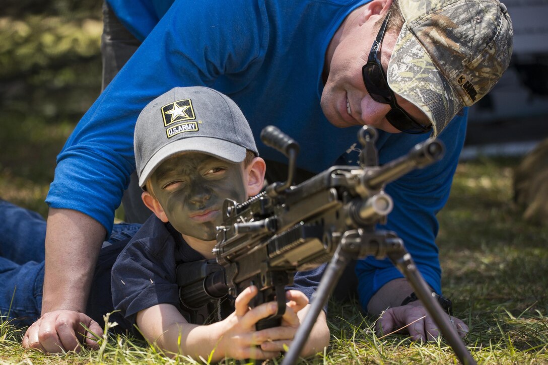 Liam Howard, 5, learns how to aim a machine gun during the 6th Ranger Training Battalion’s open house at Eglin Air Force Base, Fla., May 7, 2016. During the event, members of the public could view equipment and weapons, and learn how Rangers train. Demonstrations included hand-to-hand combat, a parachute jump and snake show. Air Force photo by Samuel King Jr.