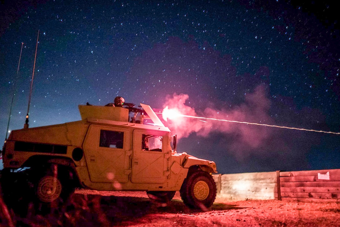 An Army military police service member shoots an M240B machine gun during night-fire qualifications at Fort Hunter Liggett, Calif., May 3, 2016. Army photo by Master Sgt. Michel Sauret
