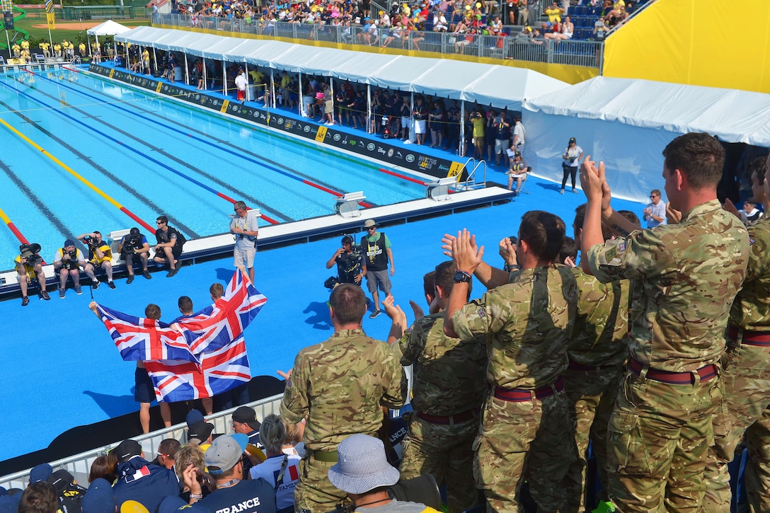 British soldiers cheer during a medal ceremony at the 2016 Invictus Games in Orlando, Fla., May 11, 2016. Army photo by Staff Sgt. Alex Manne