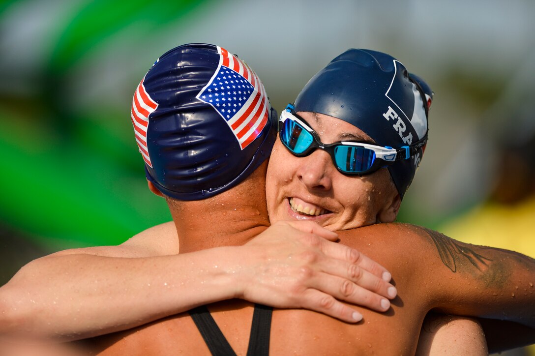 Army Sgt. Aaron Stewart, left, hugs France's Linda Coyac after competing in the 50-meter backstroke during the 2016 Invictus Games in Orlando, Fla., May 11, 2016. Air Force photo by Tech. Sgt. Joshua L. DeMotts