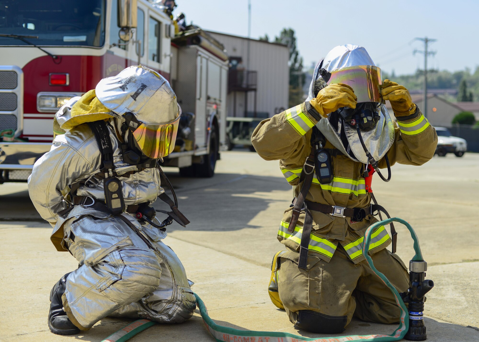 Firefighters assigned to the 51st Civil Engineer Squadron don their protective equipment before tackling a simulated vehicle fire during Exercise Beverly Herd 16-01 at Osan Air Base, Republic of Korea, May 12, 2016. The firefighters responded to the simulated fire after a mock improvised explosive device was detonated. (U.S. Air Force photo by Senior Airman Victor J. Caputo/Released)
