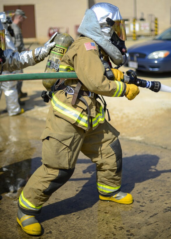 A 51st Civil Engineer Squadron firefighter operates a hose to extinguish a simulated vehicle fire during Exercise Beverly Herd 16-01 at Osan Air Base, Republic of Korea, May 12, 2016. Firefighters responded to the simulated fire after a mock improvised explosive device was detonated. (U.S. Air Force photo by Senior Airman Victor J. Caputo/Released)
