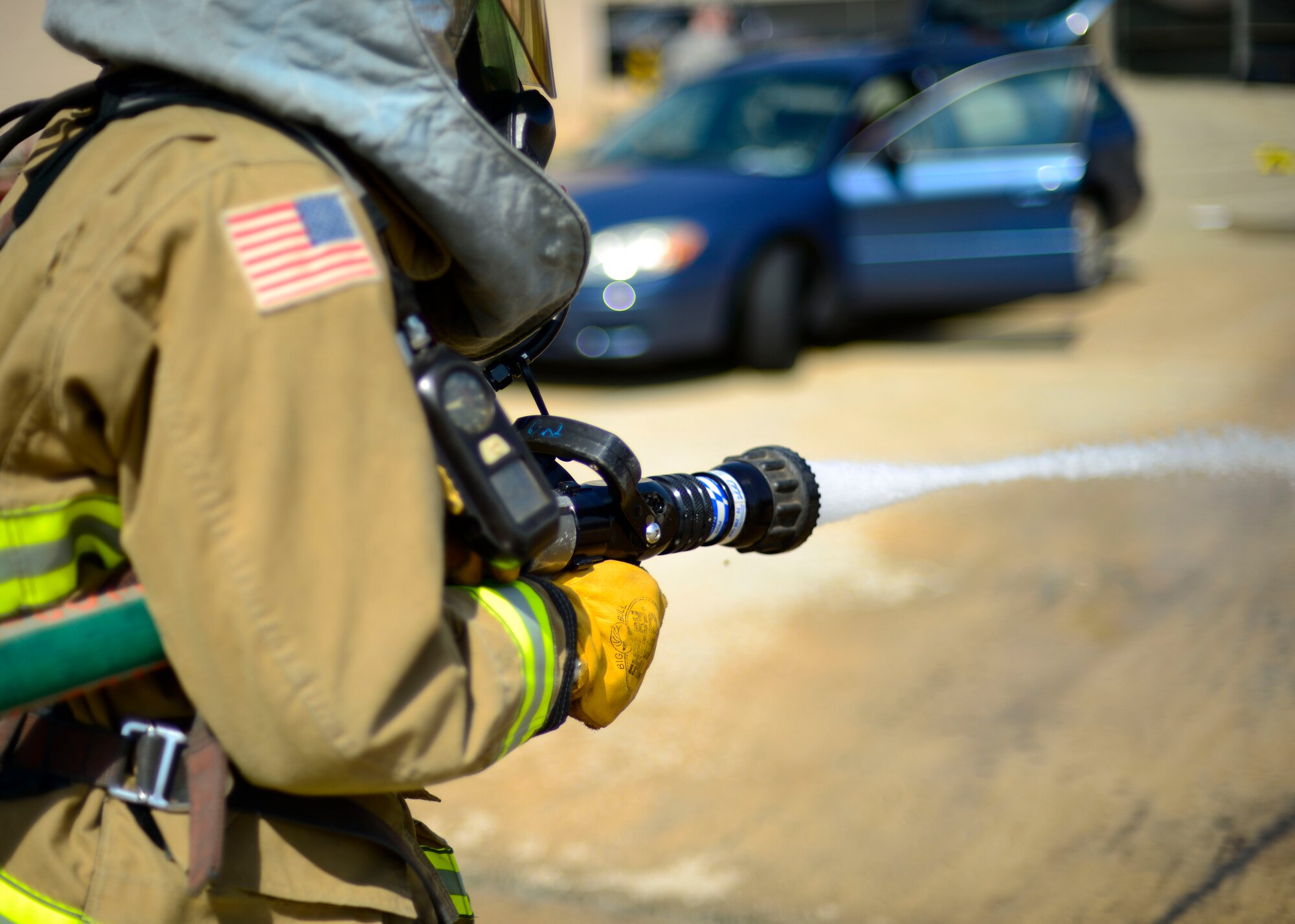 A 51st Civil Engineer Squadron firefighter operates a hose to extinguish a simulated vehicle fire during Exercise Beverly Herd 16-01 at Osan Air Base, Republic of Korea, May 12, 2016. Firefighters responded to the simulated fire after a mock improvised explosive device was detonated. (U.S. Air Force photo by Senior Airman Victor J. Caputo/Released)