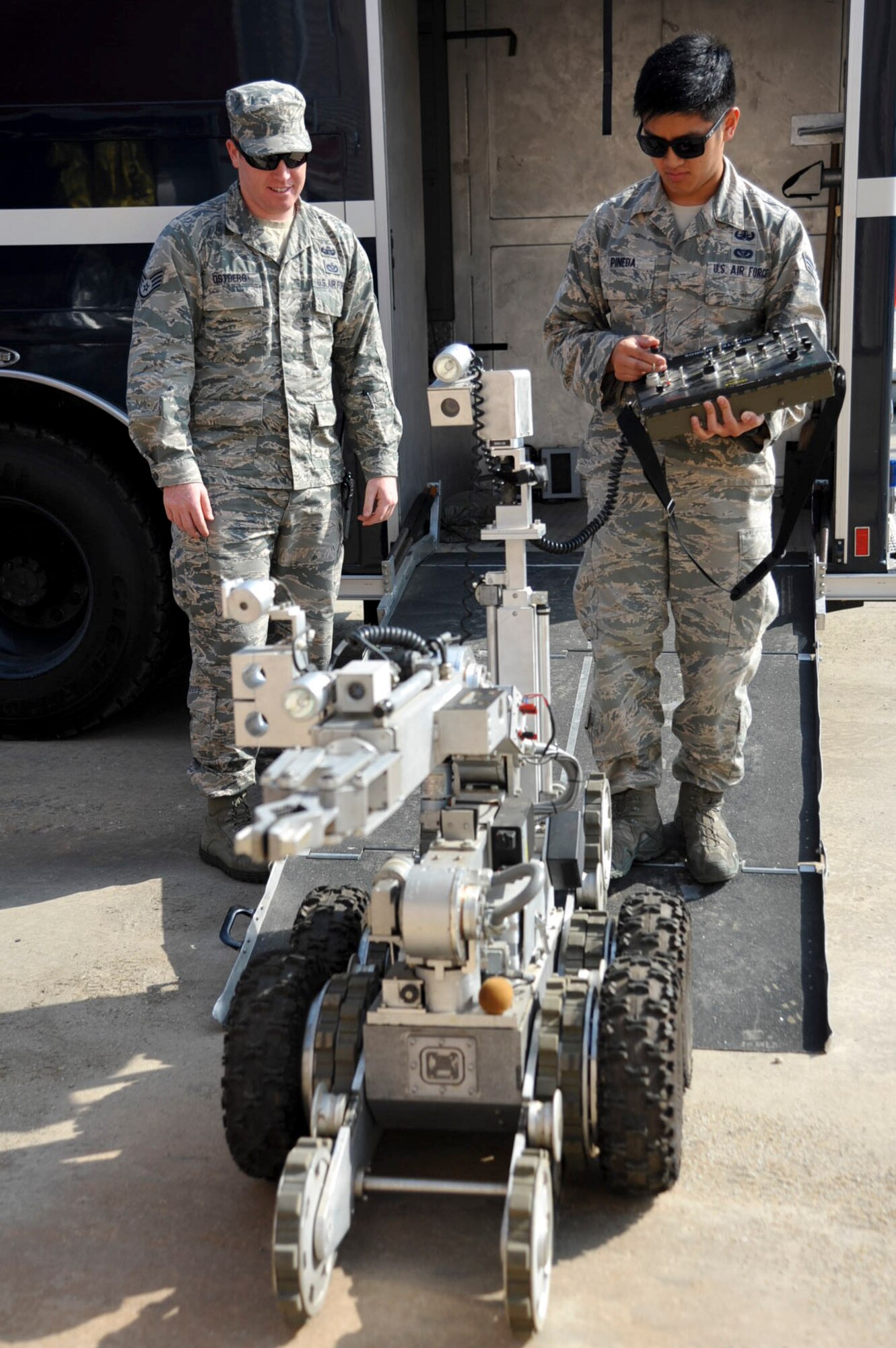 Staff Sgt. Timothy Ostberg and Staff Sgt. Paolo Pineda, 51st Civil Engineer Squadron explosive ordnance disposal technicians, operate an F6A EOD robot during a mock chemical improvised explosive device training at Osan Air Base, Republic of Korea, May 12, 2016. The training is part of Exercise Beverly Herd 16-01 and tests their abilities to respond and operate during combat operations. (U.S. Air Force photo by Staff Sgt. Jonathan Steffen/Released)