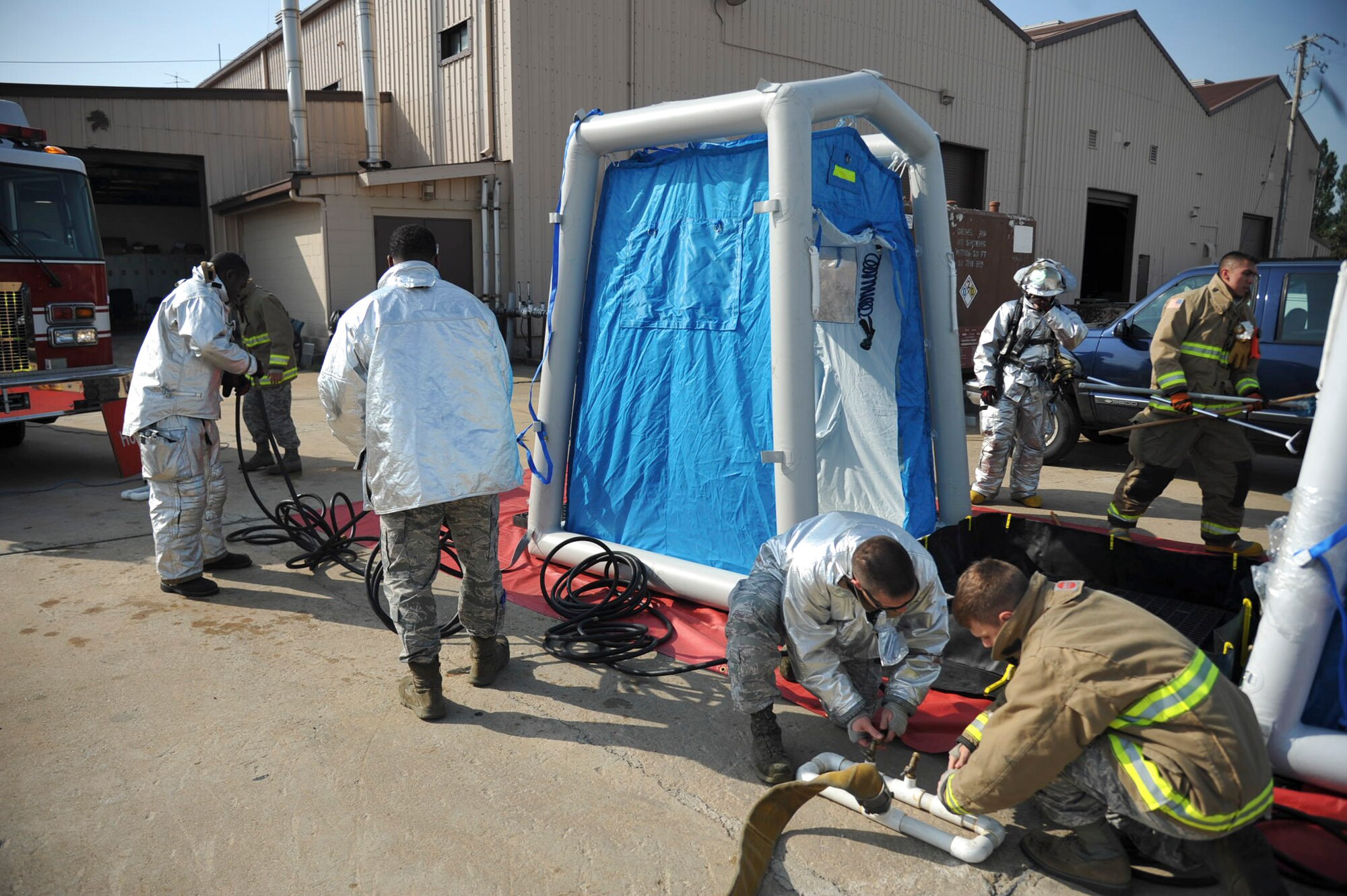 Firefighters from the 51st Civil Engineer Squadron setup a decontamination line during Exercise Beverly Herd 16-01 at Osan Air Base, Republic of Korea, May 12, 2016. The firefighters tested their skills to respond to a mock chemical improvised explosive device. (U.S. Air Force photo by Staff Sgt. Jonathan Steffen/Released)