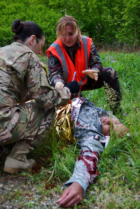 U.S. Army Sgt. Erin Hodge works with Hungarian first responders to assess victims of a simulated vehicle crash during Exercise Anakonda Response 2016, Thursday, May 5, 2016 at Papa Air Base. 