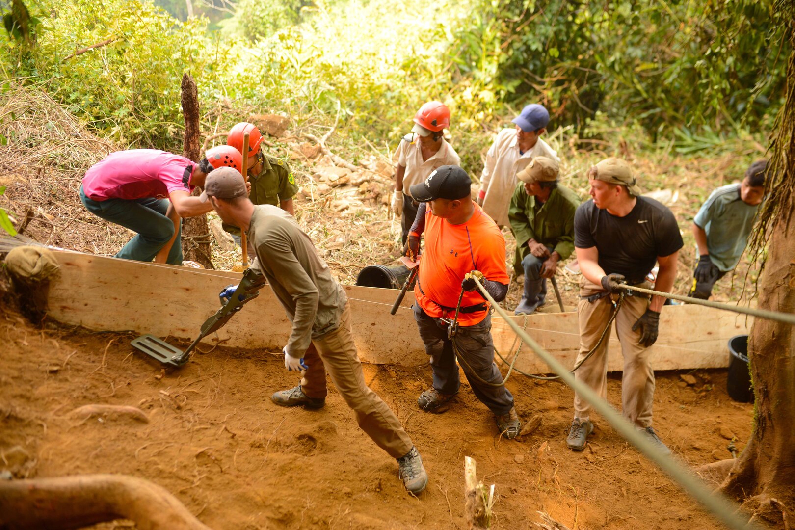 Members of 16-2VM Recovery Team One with the Defense POW/MIA Accounting Agency (DPAA), wait as U.S. Air Force Tech. Sgt. David Speigel scans an excavation unit of hazardous materials, as part of a DPAA recovery mission in To Mo Rong District, Kun Tum Province, Socialist Republic of Vietnam, March 23, 2016. DPAA teammates deployed to the area in hopes of recovering the remains of a pilot unaccounted-for from the Vietnam War.  The mission of DPAA is to provide the fullest possible accounting for our missing personnel to their families and the nation.  (DoD photo by U.S. Army Sgt. Richard DeWitt/Released)