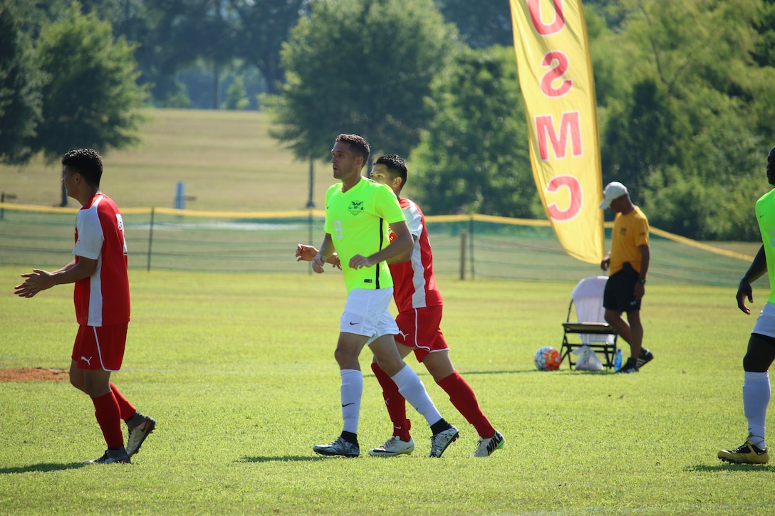 Ensign Gabe Merla (center yellow) scored the opening goal of the match lifting Navy over the Marines 2-1 to win match five of the 2016 Armed Forces Men's Soccer Championship hosted at Fort Benning, Ga from 6-14 May 2016.  Navy advances to the Championship Match versus Air Force.