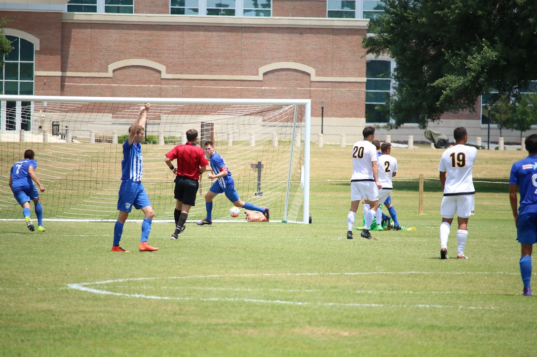 2nd lt. Taylor Moore (center in goal) boots in the first goal of the game lifting Air Force over Army for the 3-0 win in match six of the 2016 Armed Forces Men's Soccer Championship hosted at Fort Benning, Ga from 6-14 May 2016.  Air Force advances to the Championship Match versus Navy.