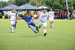 Air Force Senior Airman Jose Guillan (blue) shoots for the final goal of the game as Air Force defeats Army 3-0 win in match six of the 2016 Armed Forces Men's Soccer Championship hosted at Fort Benning, Ga from 6-14 May 2016.  Air Force advances to the Championship Match versus Navy.