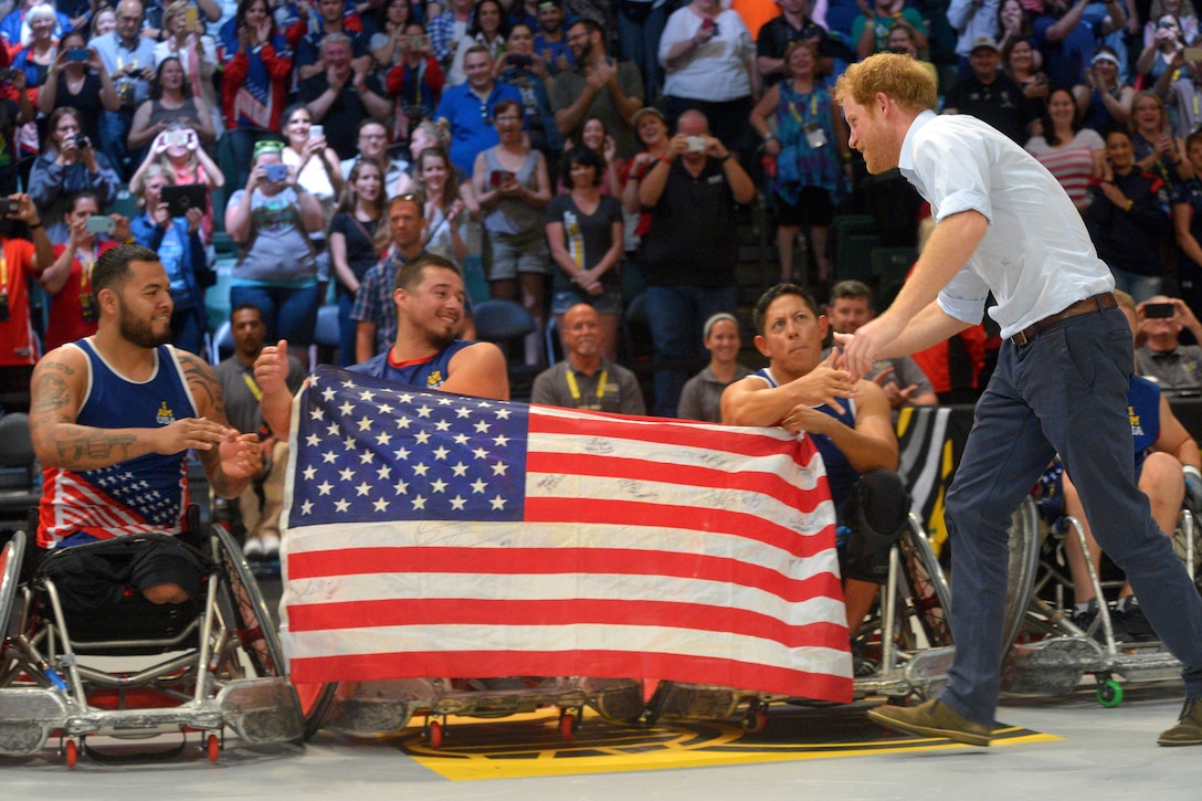 Prince Harry, right, congratulates members of the U.S. team following their gold medal victory in the wheelchair rugby finals at the 2016 Invictus Games in Orlando, Fla., May 11, 2016. Army photo by Staff Sgt. Alex Manne