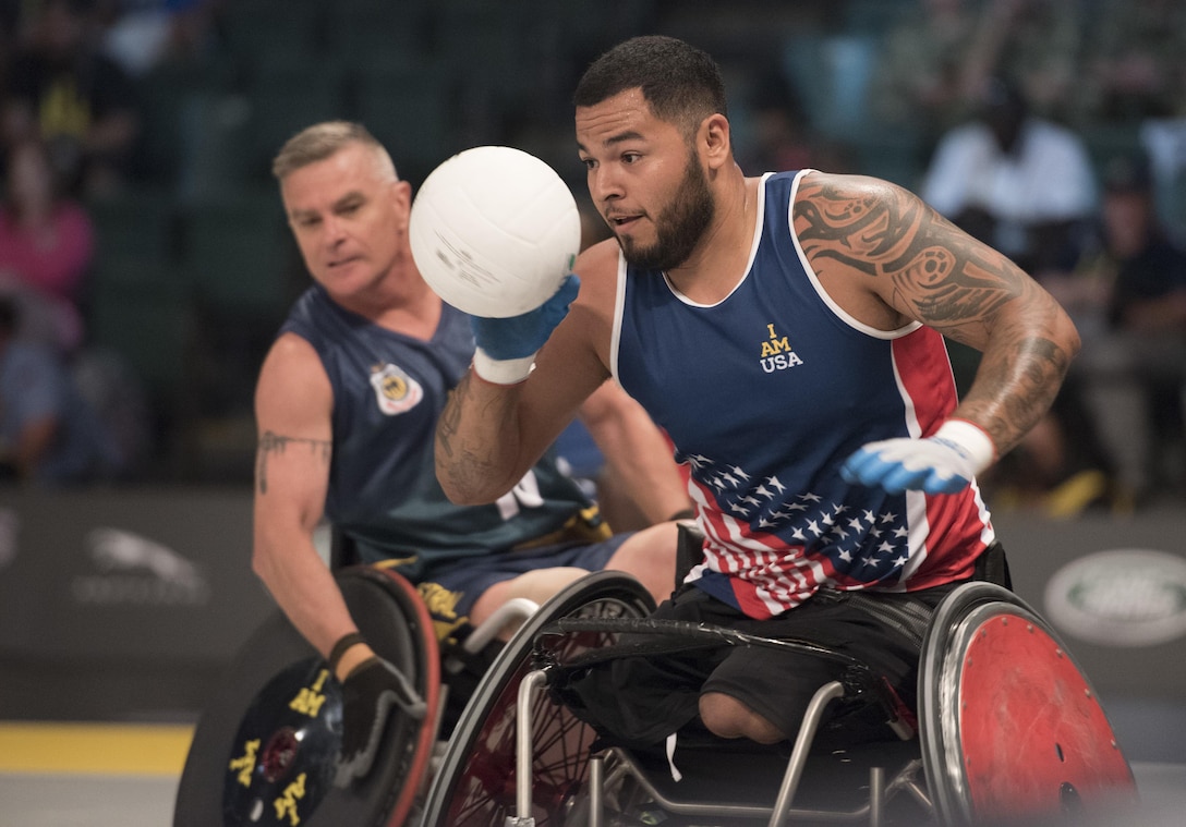 Marine Corps veteran Jorge Salazar corrals the ball during a semifinal wheelchair rugby match against Australia at the 2016 Invictus Games in Orlando, Fla., May 11, 2016. DoD photo by Roger Wollenberg