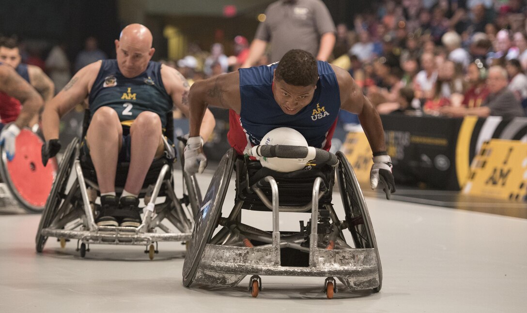 U.S. Special Operations Command veteran Ryan Major rushes toward the goal for a point against the Australian team during a semifinal wheelchair rugby match at the 2016 Invictus Games in Orlando, Fla., May 11, 2016. DoD photo by Roger Wollenberg