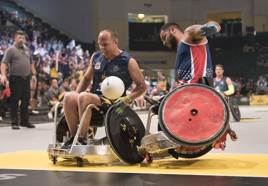 Marine Corps veteran Jorge Salazar, right, collides with an Australian player going for the ball during a semifinal wheelchair rugby match at the 2016 Invictus Games in Orlando, Fla., May 11, 2016. DoD photo by Roger Wollenberg
