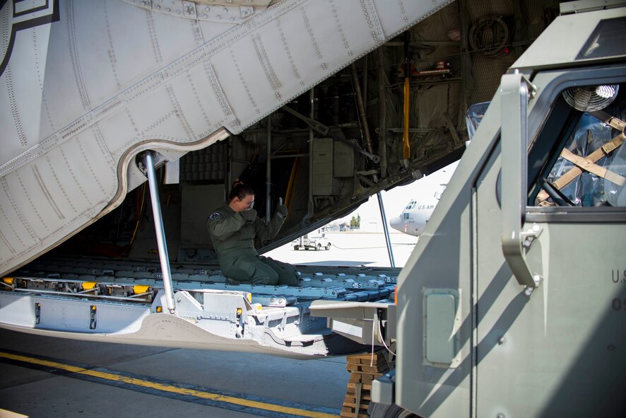 Master Sgt. Anne Majdecki, 914 Operations Group, directs a load onto a C-130 Hercules aircraft, Niagara Falls Air Reserve Station, N.Y., May 6, 2016. The cargo, containing maintenance kits and aircrew flight equipment, will be shipped, alongside deployers, to Qatar to support Operation Inherent Resolve. (U.S. Air Force photo by Tech. Sgt. Stephanie Sawyer) 