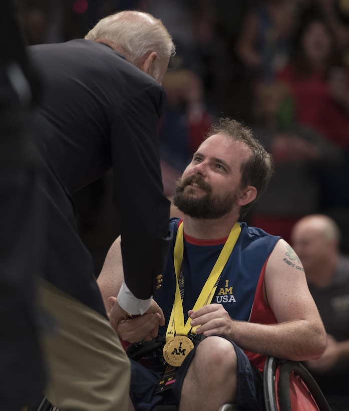 Vice President Joe Biden congratulates U.S. Special Operations Command veteran Patrick Smith after the U.S. defeated Denmark in their wheelchair rugby finals match to win the gold medal during the 2016 Invictus Games in Orlando, Fla., May 11, 2016. DoD photo by Roger Wollenberg