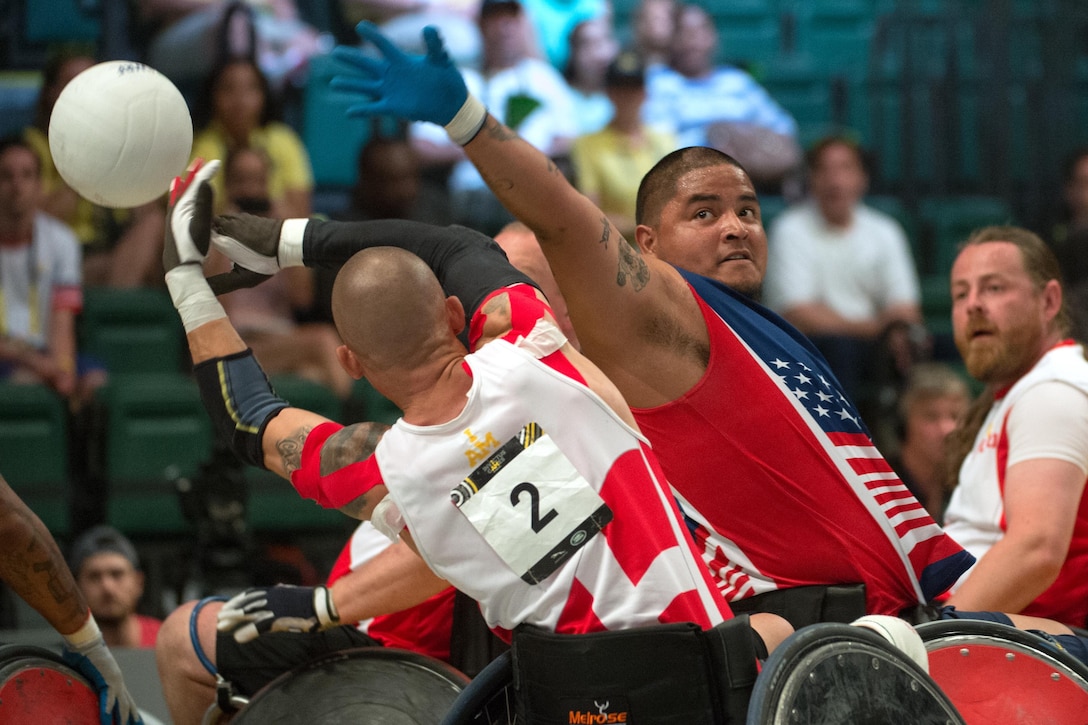Marine Corps veteran Alex Nguyen, right, prevents a pass in the gold medal wheelchair rugby match at the 2016 Invictus Games in Orlando, Fla., May 11, 2016. DoD photo by Edward Joseph Hersom II