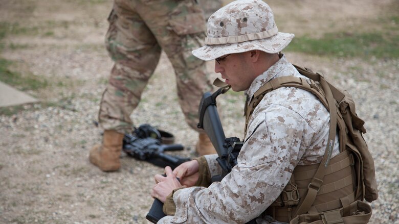 Sgt. Jose Arroyo, a competitor with the Marine Corps Shooting Team, loads a magazine at the moving target range at Puckapunyal in Victoria, Australia, May 2, 2016. The MCST joined 20 international teams to compete in the Australian Army Skill at Arms Meeting 2016. The competition tested military marksmen in their capabilities with their service specific weaponry in various scenarios. 