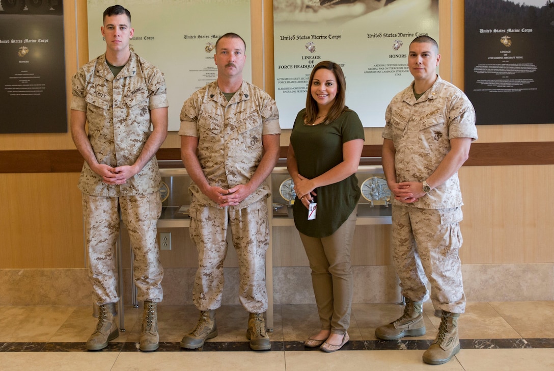 Marines with the 4th Marine Logistics Group Headquarters G-4, Marine Forces Reserve, and a civilian employee with MARFORRES, were honored at the Distinguished Service Awards and Luncheon Program as a part of Public Service Recognition Week, May 4, 2016 at the University of New Orleans. From left to right, Lance Cpl. Coltin J. Kersey, embarkation clerk, Sgt. Justin A. Snapp, maintenance management chief, Mrs. Janet Heriot, customer service support specialist with the MARFORRES Installation Personnel Administration Center, and Maj. John J. Gutierrez, supply officer, were recognized for their hard work and dedication in supporting the Marine Corps, as well as the local community. With the geographical diversity of MARFORRES, Marines have the unique opportunity to interact with the local community and American public on a daily basis. This involvement helps keep the future bright for the Marine Corps and the community as a whole. (U.S. Marine Corps photo by Lance Cpl. Melissa Martens/ Released)